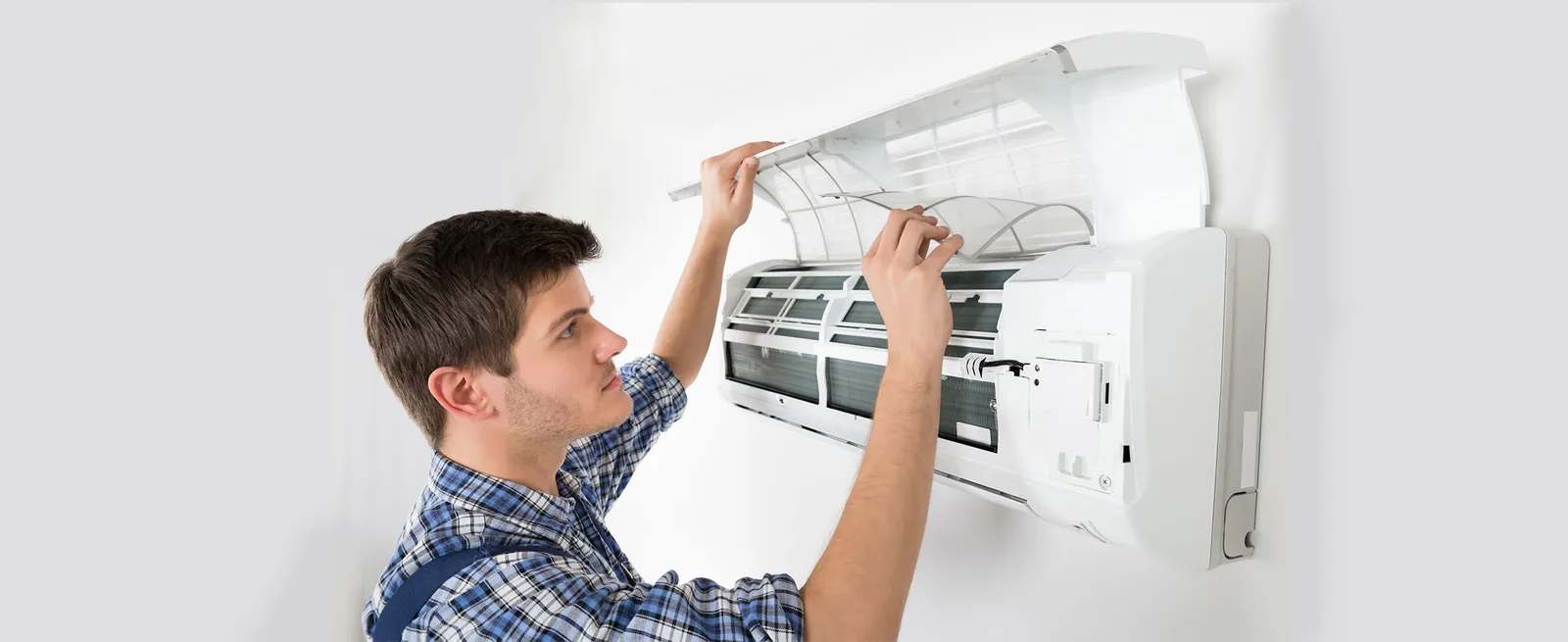 Technician servicing an air conditioner